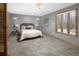 Main bedroom with wall sconces, natural light and neutral-toned carpet and walls at 32252 Steven Way, Conifer, CO 80433