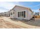 Backyard view of the home featuring a bay window, sliding doors, and patio at 9712 Cathay St, Commerce City, CO 80022