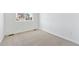 Bright bedroom with neutral carpet, white walls, and ample natural light at 9712 Cathay St, Commerce City, CO 80022