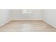Clean, bright room with durable wood-look flooring and a minimalist aesthetic at 9712 Cathay St, Commerce City, CO 80022