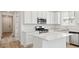 Well-lit kitchen with stainless steel appliances and a stylish central island at 9712 Cathay St, Commerce City, CO 80022