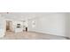 Open floorplan shows the kitchen with white cabinets, island, and stainless appliances at 9712 Cathay St, Commerce City, CO 80022