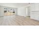 Bright living room with light wood floors, large sliding glass doors and neutral paint at 9712 Cathay St, Commerce City, CO 80022