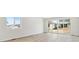 Bright living room with light wood floors, large windows and neutral paint at 9712 Cathay St, Commerce City, CO 80022