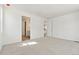 Bright main bedroom with plush carpet and access to en-suite bathroom and walk-in closet at 9712 Cathay St, Commerce City, CO 80022