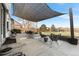Spacious outdoor patio featuring stylish furniture, a shade sail, and a well-maintained fenced yard at 2331 Ance St, Strasburg, CO 80136