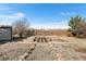 Backyard area with several wooden garden boxes surrounded by decorative rocks and mulch at 2331 Ance St, Strasburg, CO 80136