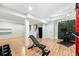 Spacious finished basement with workout area, laminate flooring, and utility area at 2331 Ance St, Strasburg, CO 80136