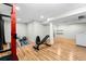 Basement gym area featuring weightlifting equipment and laminate flooring, perfect for fitness enthusiasts at 2331 Ance St, Strasburg, CO 80136
