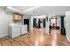 Finished basement laundry room with a workout area featuring laminate wood flooring at 2331 Ance St, Strasburg, CO 80136