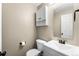 Well lit half bathroom with vanity and toilet. Clean and functional at 2331 Ance St, Strasburg, CO 80136