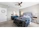 Cozy bedroom showcasing a tufted headboard, complemented by modern nightstands and a decorative mirror, providing comfort and style at 2331 Ance St, Strasburg, CO 80136