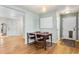 Dining area with hardwood floors, modern light fixtures, and access to other rooms at 2331 Ance St, Strasburg, CO 80136