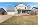 Charming two-story home featuring a covered front porch, attached garage, and a well-maintained front yard at 2331 Ance St, Strasburg, CO 80136