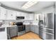 Well-lit kitchen featuring stainless steel appliances, light countertops, and ample cabinet space at 2331 Ance St, Strasburg, CO 80136