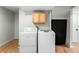 Basement laundry room equipped with modern washer and dryer, set against laminate flooring at 2331 Ance St, Strasburg, CO 80136