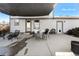Inviting covered patio with elegant dining set and comfortable seating arrangement at 2331 Ance St, Strasburg, CO 80136