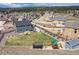 Aerial view of backyard featuring a built in BBQ, fire pit, patio, playground, and green space at 795 Woodmoor Acres Dr, Monument, CO 80132