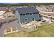 Aerial shot of a backyard featuring a built in BBQ, fire pit, patio, and green space at 795 Woodmoor Acres Dr, Monument, CO 80132