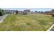 Expansive backyard with lush green grass, playground, shed, and fenced perimeter at 795 Woodmoor Acres Dr, Monument, CO 80132