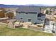 Outdoor living space features a built-in fireplace, seating area, bar, and basketball hoop at 795 Woodmoor Acres Dr, Monument, CO 80132