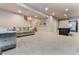 Finished basement features neutral carpet and light walls with a couch and game table at 795 Woodmoor Acres Dr, Monument, CO 80132