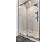 Bathroom with walk-in shower features light marble-look tile, glass door and rain shower head at 795 Woodmoor Acres Dr, Monument, CO 80132