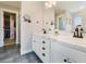 Dual sink bathroom features marble countertops, dual mirrors and black hardware and access to a walk-in closet at 795 Woodmoor Acres Dr, Monument, CO 80132