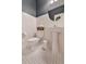 Stylish half bath showcases white subway tile walls, pedestal sink, patterned floors and striking blue ceiling at 795 Woodmoor Acres Dr, Monument, CO 80132