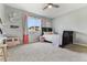 Light-filled bedroom with a ceiling fan, a large window, and soft carpet at 795 Woodmoor Acres Dr, Monument, CO 80132