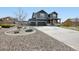 Charming two-story home features a large driveway, well-manicured landscaping, and a welcoming front porch at 795 Woodmoor Acres Dr, Monument, CO 80132
