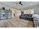 Inviting living room with wood floors, a leather sofa, and modern shelving, offers a comfortable space at 795 Woodmoor Acres Dr, Monument, CO 80132