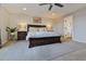 Lovely primary bedroom boasts a paneled wall, ceiling fan, and bright ensuite bathroom at 795 Woodmoor Acres Dr, Monument, CO 80132