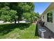Lush, green backyard with mature trees, deck, and stone landscaping elements at 9747 W Peakview Dr, Littleton, CO 80123