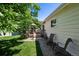 Side view of private deck, chairs and lush backyard landscaping at 9747 W Peakview Dr, Littleton, CO 80123