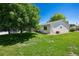 Green backyard featuring mature trees and providing a serene outdoor space at 9747 W Peakview Dr, Littleton, CO 80123