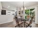 Inviting dining area with vinyl floors, modern lighting, and access to the outdoor patio at 9747 W Peakview Dr, Littleton, CO 80123