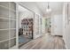 Hallway with decorative doors leading to a study and neutral paint colors and hardwood floors at 9747 W Peakview Dr, Littleton, CO 80123