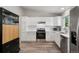 Bright kitchen featuring white cabinets, stainless steel appliances, and hardwood floors at 9747 W Peakview Dr, Littleton, CO 80123