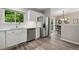 Bright kitchen with stainless steel appliances, white cabinets, and a view to the dining area at 9747 W Peakview Dr, Littleton, CO 80123