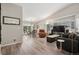 Bright living room with vaulted ceiling, hardwood floors, and sliding glass doors to patio at 9747 W Peakview Dr, Littleton, CO 80123
