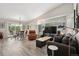 Large open concept living room with stylish furniture, large windows and access to the outdoor patio at 9747 W Peakview Dr, Littleton, CO 80123