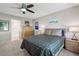 Serene main bedroom with a ceiling fan, natural light, and ensuite bathroom access at 9747 W Peakview Dr, Littleton, CO 80123