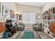 Cozy sitting area featuring comfortable chairs, warm lighting, vinyl floors and built-in shelving at 9747 W Peakview Dr, Littleton, CO 80123