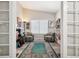 Cozy study with a large window, comfortable seating, a carpet, and custom shelving at 9747 W Peakview Dr, Littleton, CO 80123