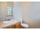 Powder bathroom featuring a tile countertop and wooden cabinetry at 6847 S Webster St # A, Littleton, CO 80128