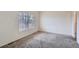 Carpeted bedroom featuring natural light through a window at 6847 S Webster St # A, Littleton, CO 80128