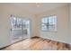 Bright bedroom featuring wood floors and a sliding glass door leading to a balcony at 6847 S Webster St # A, Littleton, CO 80128