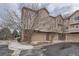 Townhome exterior displaying garages with brick accents at 6847 S Webster St # A, Littleton, CO 80128