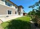 This backyard features a green lawn, a concrete patio, and a fenced yard at 9482 Kendrick Way, Arvada, CO 80007